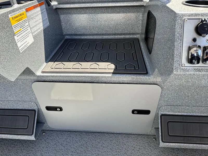 Slide: The Image of 2024 KingFisher 1825 Falcon boat interior with storage compartment and control panel. - 22
