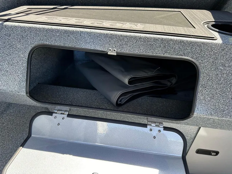 Slide: The Image of Storage compartment in 2024 KingFisher 1825 Falcon boat, featuring folded black cover. - 24