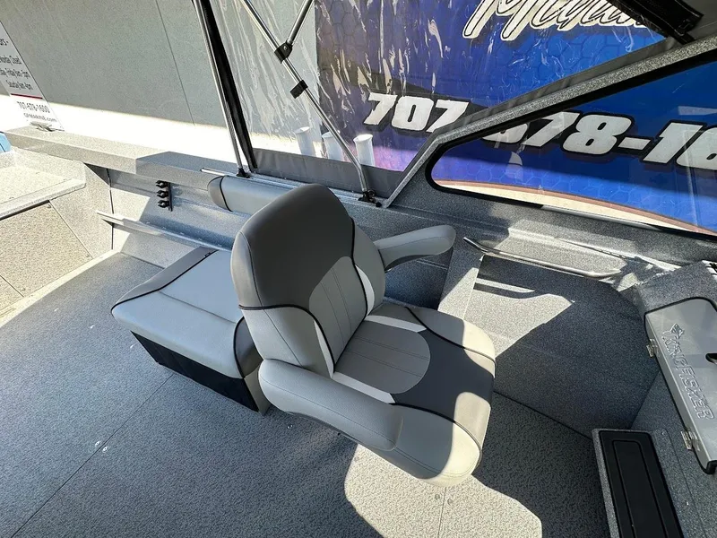 Slide: The Image of 2024 KingFisher 1825 Falcon boat interior with gray seating and dashboard. - 25