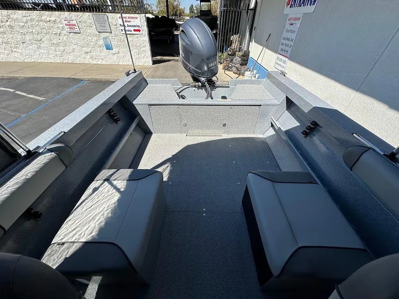 Slide: The Image of 2024 KingFisher 1825 Falcon boat interior with seating and motor. - 26