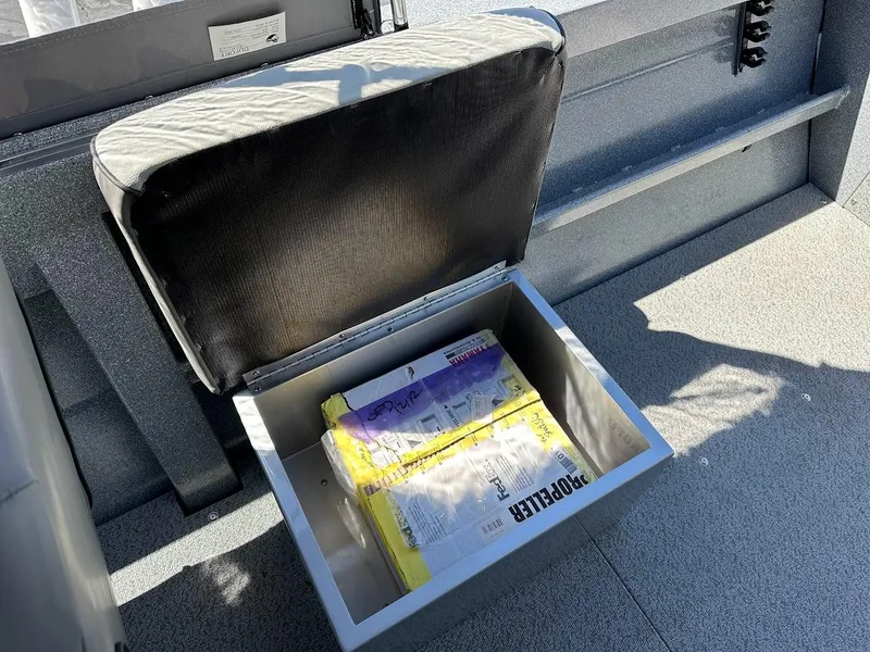 Slide: The Image of Storage compartment in 2024 KingFisher 1825 Falcon boat with manuals inside. - 27