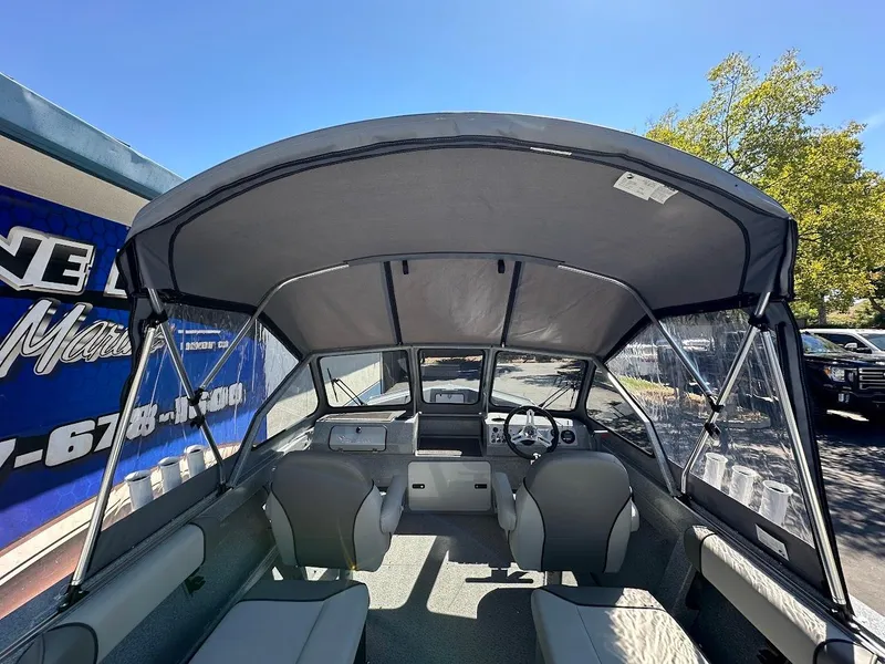 Slide: The Image of 2024 KingFisher 1825 Falcon boat interior with canopy, seats, and steering wheel. - 34