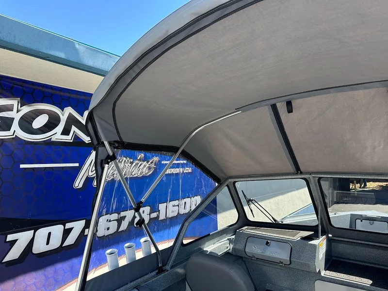 Slide: The Image of 2024 KingFisher 1825 Falcon boat interior with canopy and seating. - 35