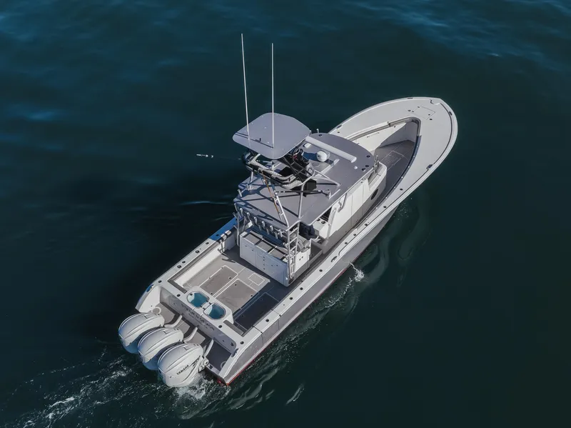 Slide: The Image of 2019 Buddy Davis 42 CC boat cruising on open water, aerial view. - 11
