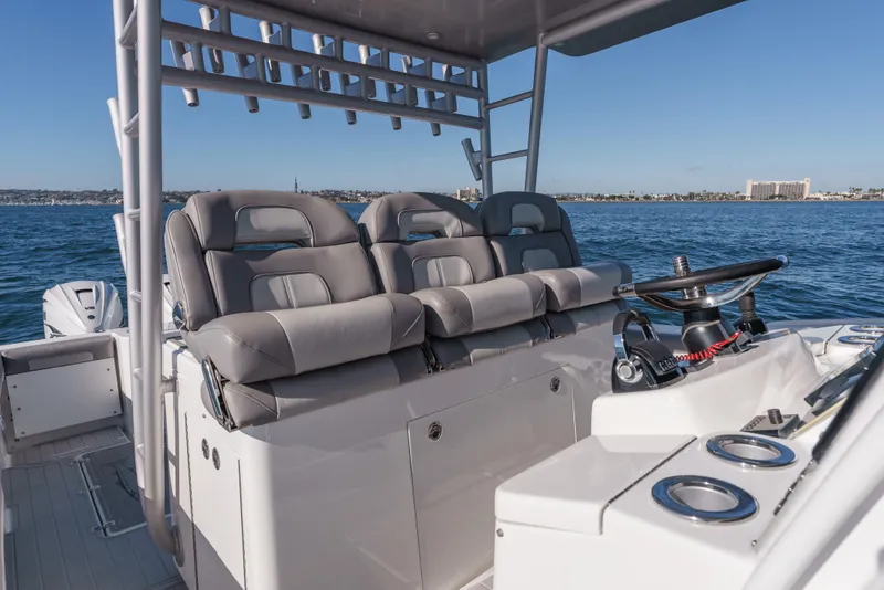 Slide: The Image of 2019 Buddy Davis 42 CC boat interior with helm and seating on open water. - 21