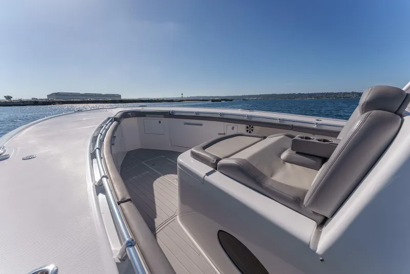 Slide: The Image of 2019 Buddy Davis 42 CC boat deck with seating, overlooking calm waters and clear blue sky. - 23