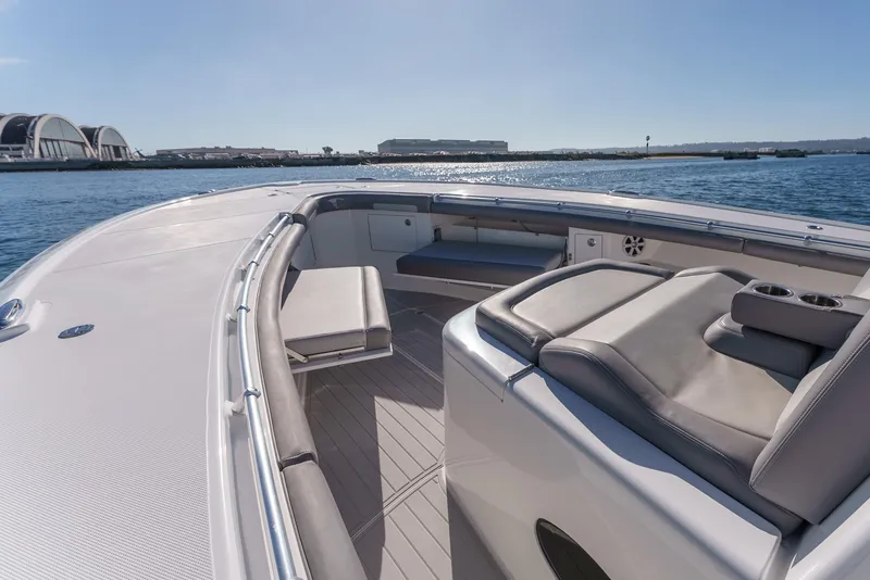 Slide: The Image of 2019 Buddy Davis 42 CC boat interior with luxurious seating on calm water. - 24