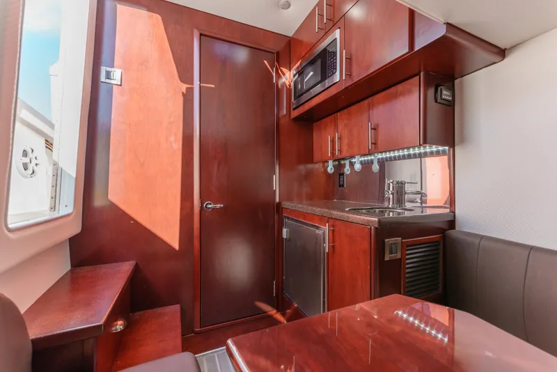 Slide: The Image of Interior of 2019 Buddy Davis 42 CC boat with kitchenette and seating area. - 30