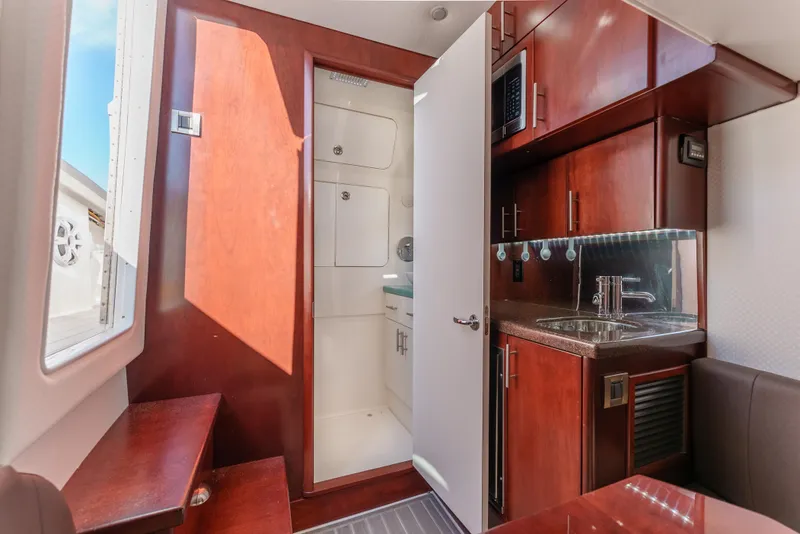Slide: The Image of Interior of 2019 Buddy Davis 42 CC boat with kitchenette and wooden cabinetry. - 31