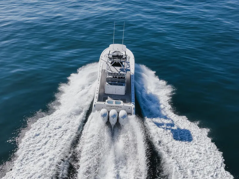 Slide: The Image of 2019 Buddy Davis 42 CC boat cruising on open water, aerial view. - 5