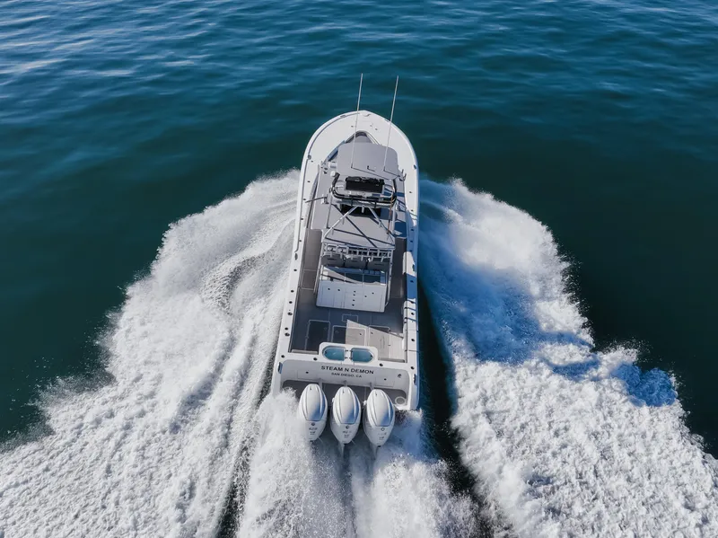 Slide: The Image of 2019 Buddy Davis 42 CC boat cruising on open water, aerial view. - 6