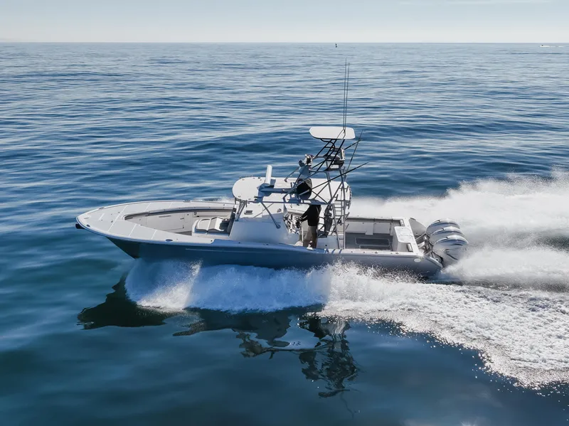 Slide: The Image of 2019 Buddy Davis 42 CC boat cruising on open water, showcasing sleek design and powerful engines. - 7