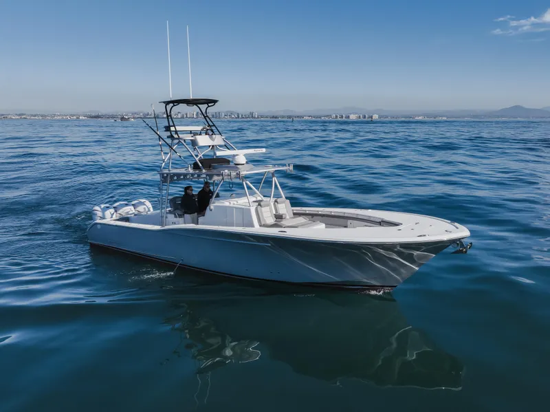 Slide: The Image of 2019 Buddy Davis 42 CC boat cruising on open water under clear blue skies. - 8