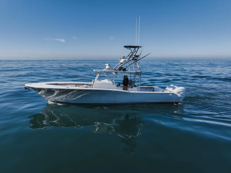 Slide: The Image of 2019 Buddy Davis 42 CC boat on calm ocean waters under clear blue sky. - 9
