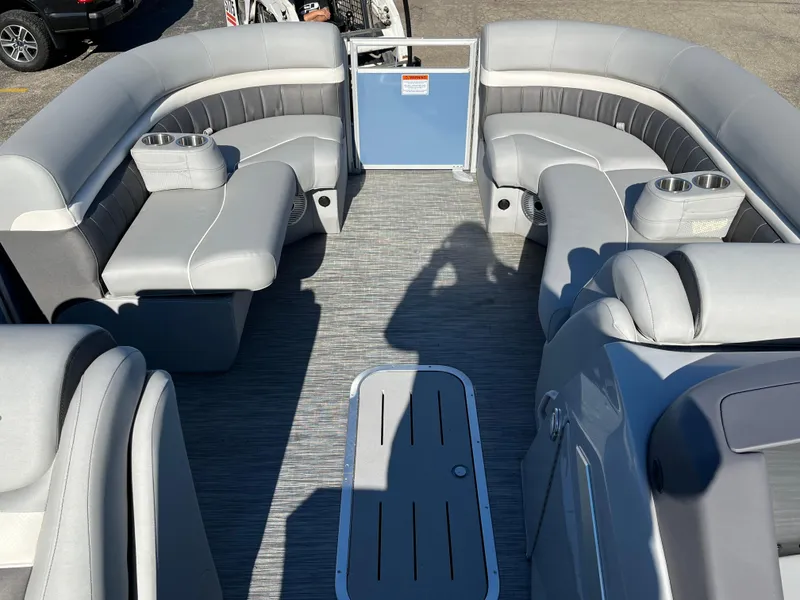 Slide: The Image of 2023 Bennington L Line pontoon boat interior with gray seating and cup holders. - 10