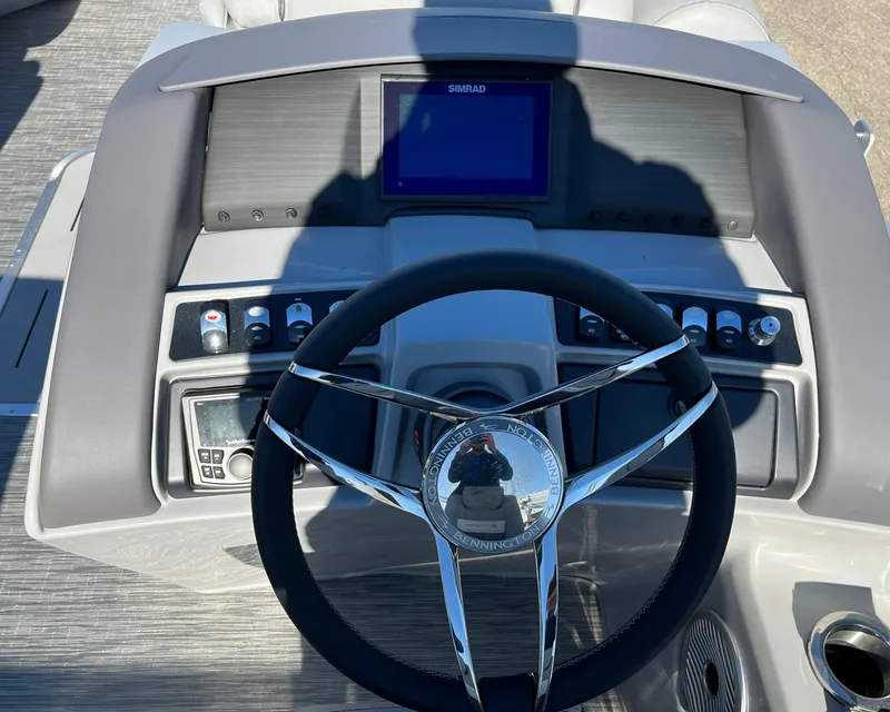 Slide: The Image of 2023 Bennington L Line boat dashboard with steering wheel and control panel. - 4