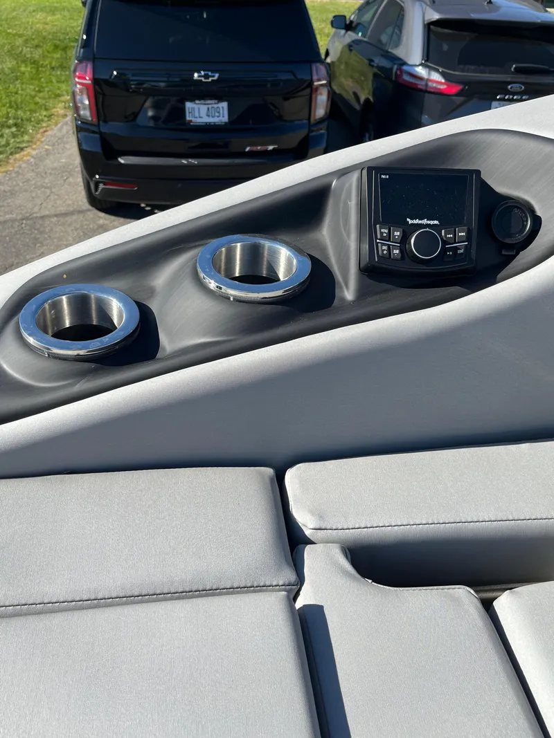 Slide: The Image of 2023 Bennington L Line boat interior with cup holders and control panel. - 8