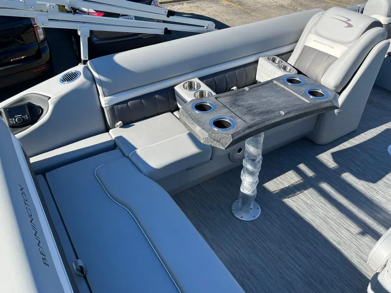 Slide: The Image of 2023 Bennington L Line boat interior with gray seating and table. - 9