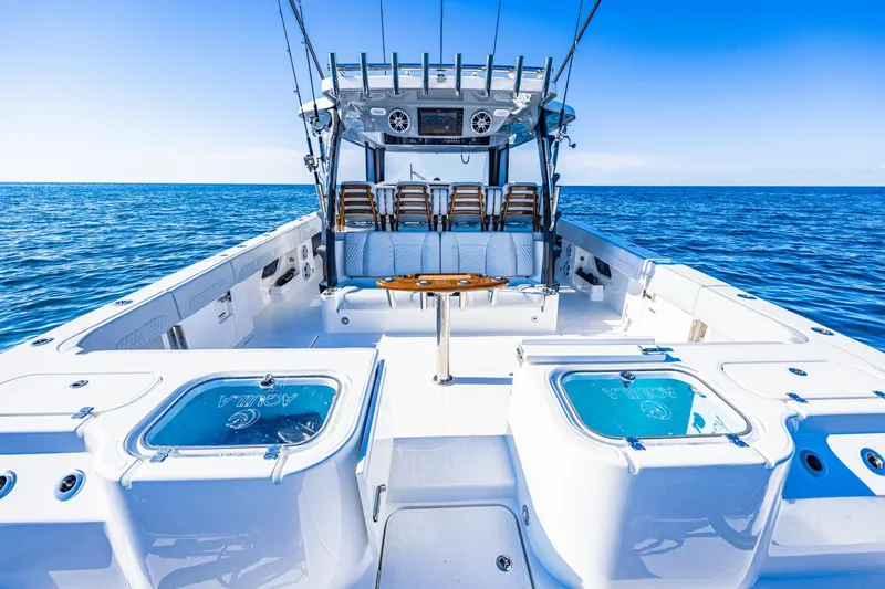 Slide: The Image of 2024 Aquila 47 Molokai boat interior with fishing gear and ocean backdrop. - 15