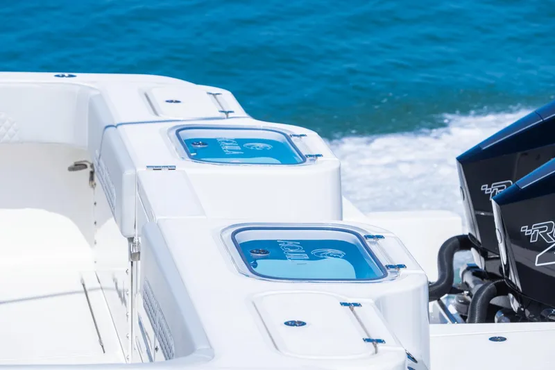 Slide: The Image of 2024 Aquila 47 Molokai boat with dual outboard engines on the water. - 22