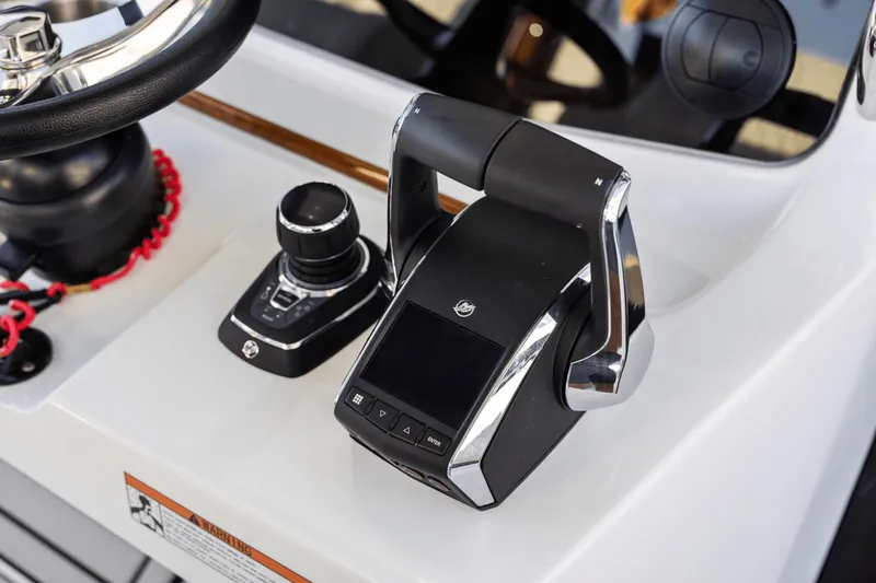 Slide: The Image of Close-up of the 2024 Aquila 47 Molokai boat's control panel and throttle. - 23