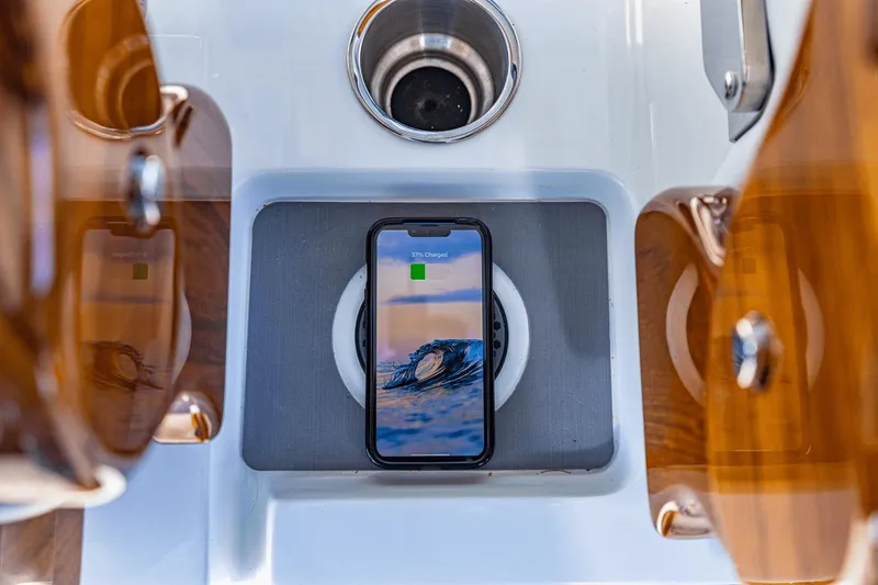 Slide: The Image of Smartphone charging on Aquila 47 Molokai 2024 boat's wireless charging pad. - 27