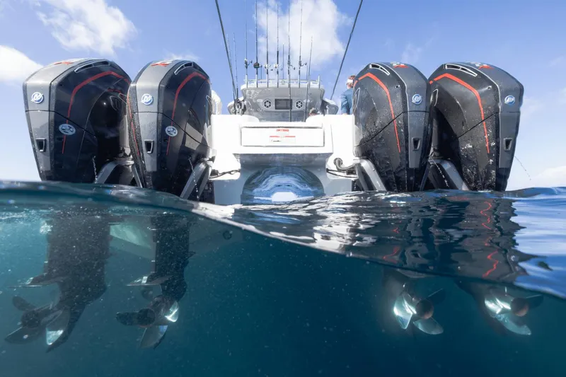 Slide: The Image of Aquila 47 Molokai 2024 boat with four powerful outboard engines in water. - 6