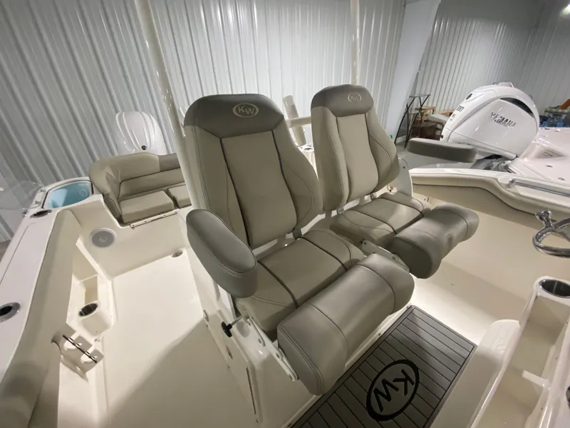 Slide: The Image of 2024 Key West 263 FS boat interior with dual captain's chairs and cushioned seating. - 16