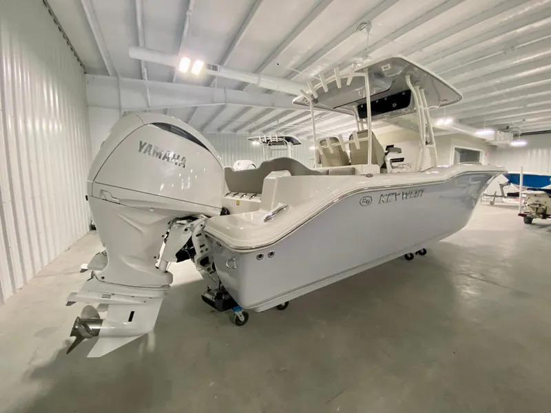Slide: The Image of 2024 Key West 263 FS boat with Yamaha outboard motor in a showroom. - 2