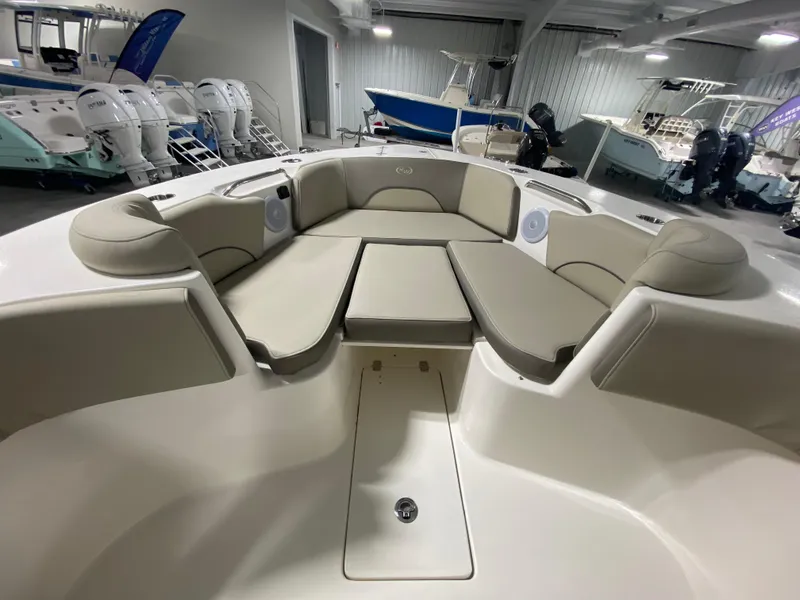 Slide: The Image of 2024 Key West 263 FS boat interior with cushioned seating in showroom. - 23
