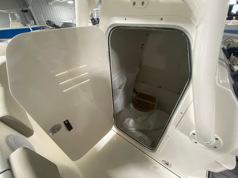 Slide: The Image of 2024 Key West 263 FS boat interior storage compartment with open door. - 25