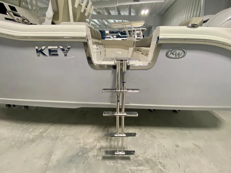 Slide: The Image of 2024 Key West 263 FS boat with rear ladder in showroom. - 4