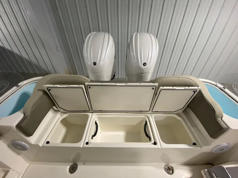 Slide: The Image of 2024 Key West 263 FS boat with open storage compartments and dual engines. - 8