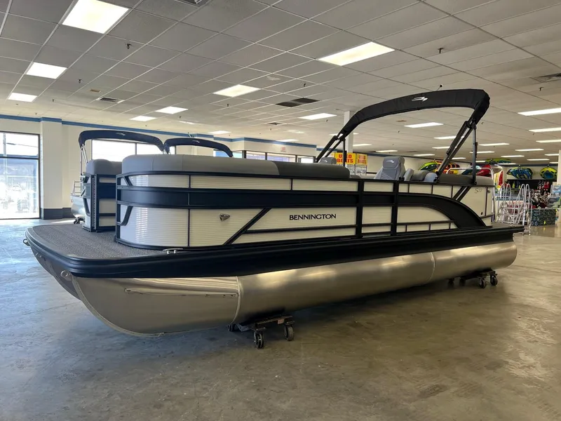Slide: The Image of 2024 Bennington S Line pontoon boat displayed indoors. - 1