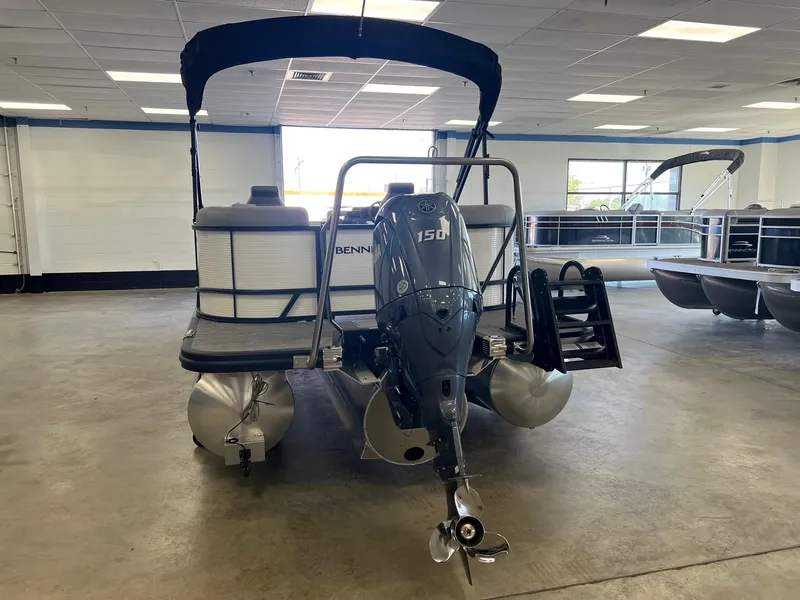 Slide: The Image of 2024 Bennington S Line pontoon boat with 150 HP engine in showroom. - 10