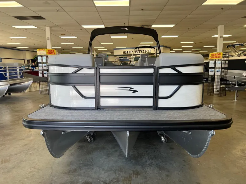 Slide: The Image of 2024 Bennington S Line pontoon boat displayed in showroom. - 2