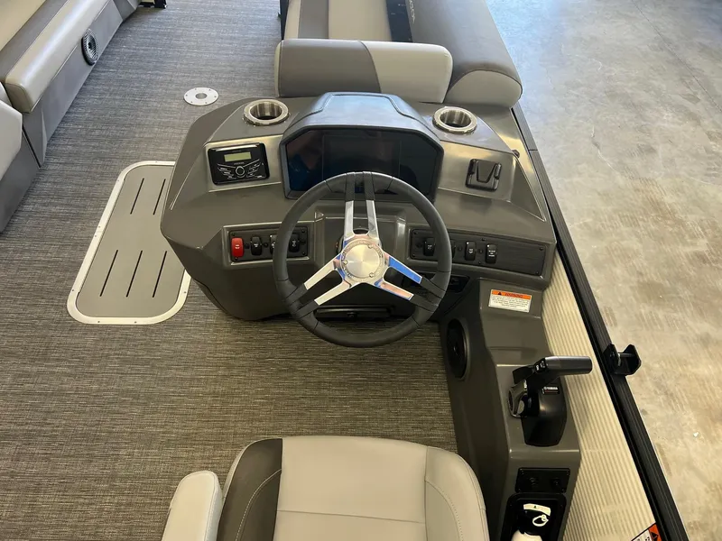 Slide: The Image of 2024 Bennington S Line boat dashboard with steering wheel and controls. - 6
