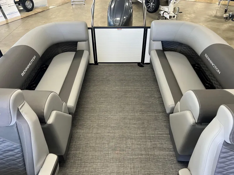 Slide: The Image of 2024 Bennington S Line pontoon boat interior with gray seating and carpeted floor. - 9