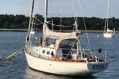 Slide: The Image of 1966 Tripp 31 Masthead Sloop sailboat anchored on calm water. - 1