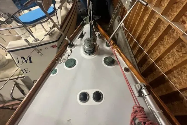 Slide: The Image of 1966 Tripp 31 Masthead Sloop deck with winch and rigging in storage. - 16