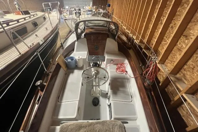 Slide: The Image of 1966 Tripp 31 Masthead Sloop in storage, showcasing cockpit and steering wheel. - 20
