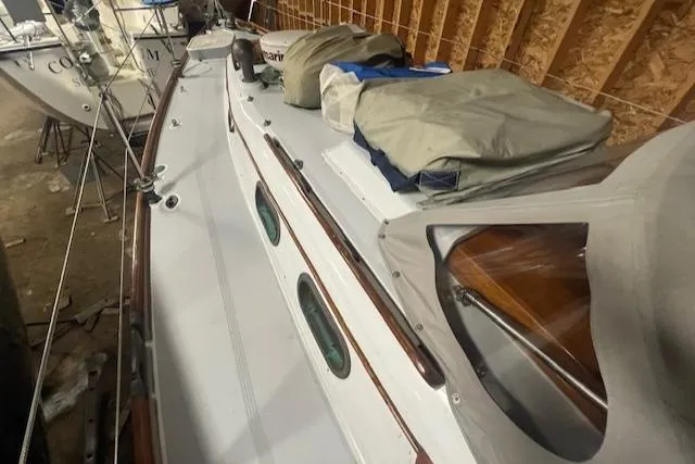 Slide: The Image of 1966 Tripp 31 Masthead Sloop sailboat in storage, covered with tarps. - 21