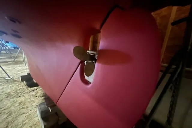 Slide: The Image of Red hull of 1966 Tripp 31 Masthead Sloop with visible propeller. - 23