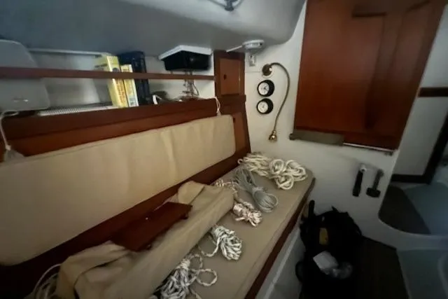 Slide: The Image of Interior of a 1966 Tripp 31 Masthead Sloop with ropes and wooden cabinetry. - 3
