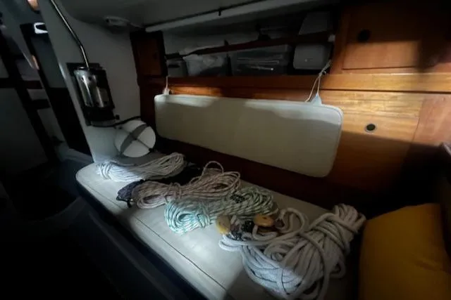 Slide: The Image of Interior of 1966 Tripp 31 Masthead Sloop with ropes and wooden cabinetry. - 4