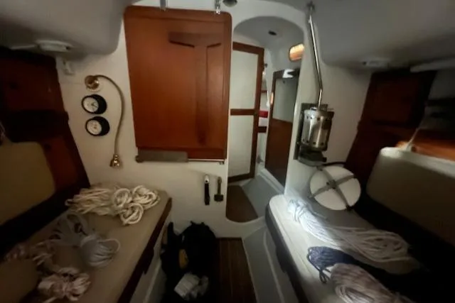 Slide: The Image of Interior of 1966 Tripp 31 Masthead Sloop with ropes and wooden cabinetry. - 5