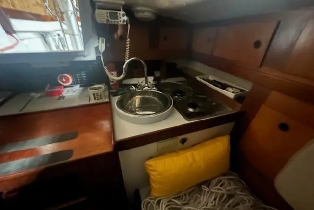 Slide: The Image of Interior of 1966 Tripp 31 Masthead Sloop with compact kitchen and wooden cabinetry. - 6