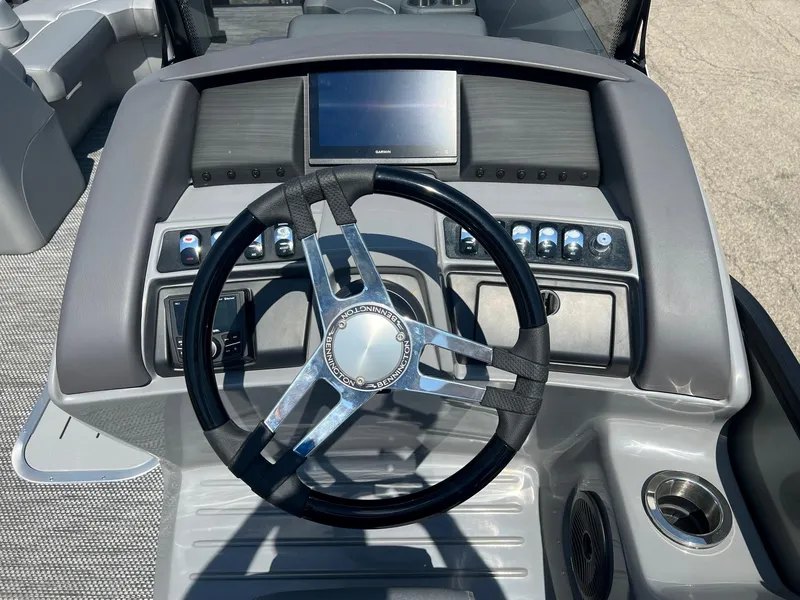 Slide: The Image of 2024 Bennington LX Sport Line boat dashboard with steering wheel and controls. - 7