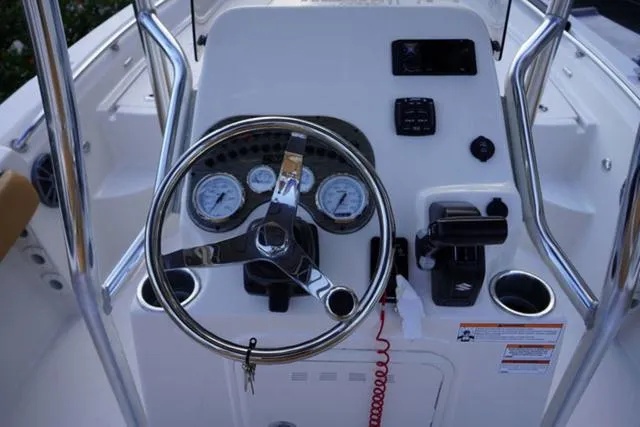 Slide: The Image of 2024 Sea Chaser 21 LX boat console with steering wheel and gauges. - 13