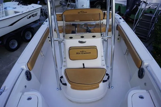 Slide: The Image of 2024 Sea Chaser 21 LX boat interior with tan seating and center console. - 3